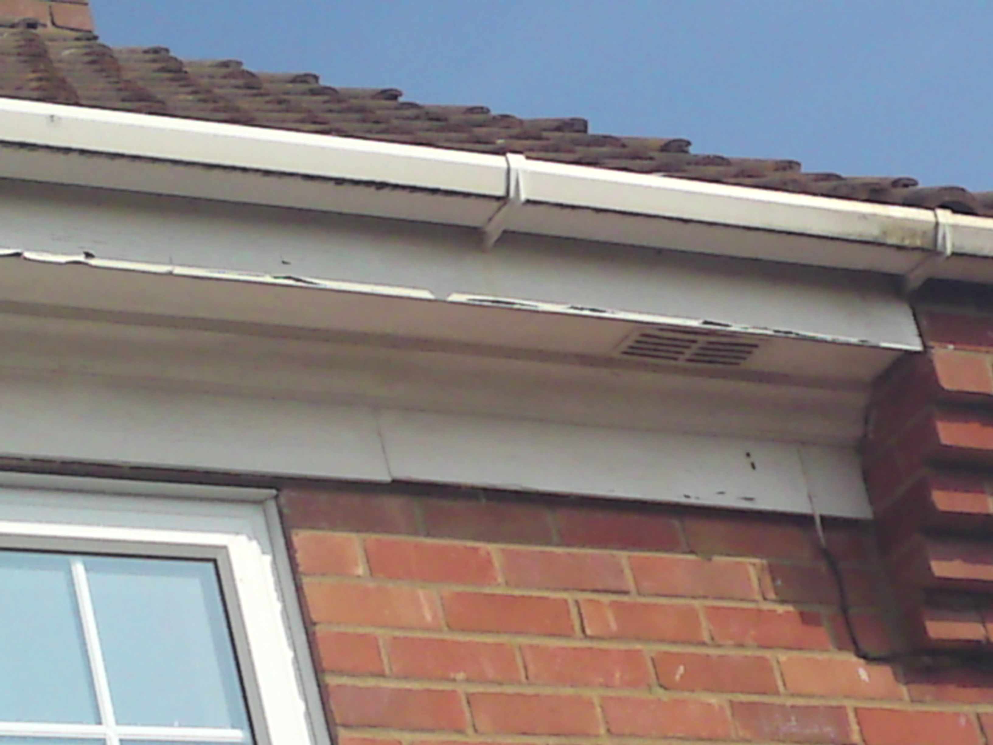 Discoloured guttering & flaking paintwork